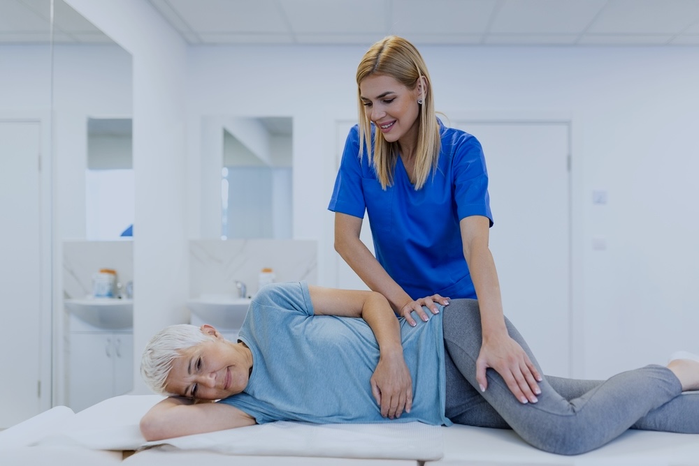 Female client with a nurse undergoing elderly rehabilitation therapy