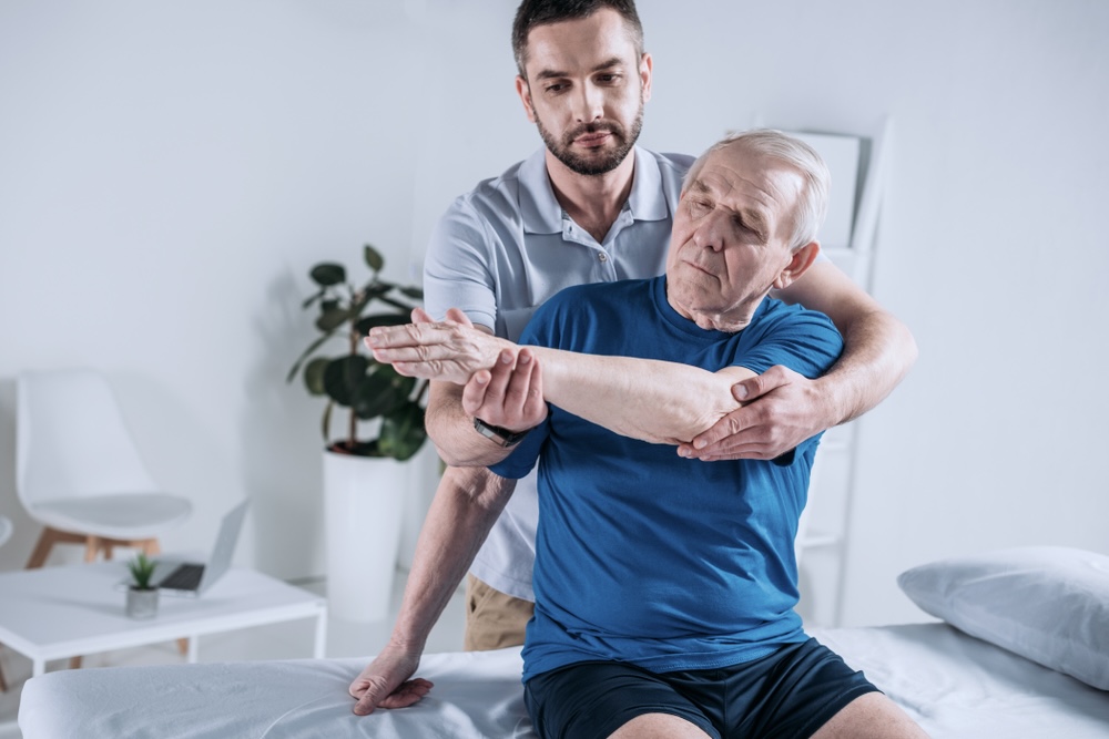 Male elderly client during elderly rehabilitation therapy