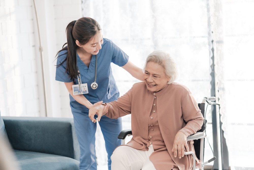 Staff assisting elderly in nursing care